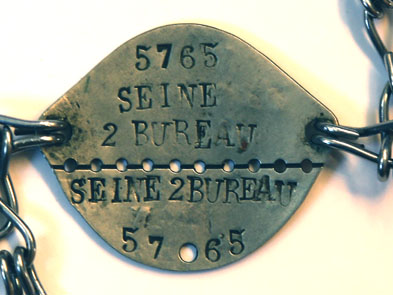 Gourmette militaire de Jean - Classe 1934 <p>Verso</p>© Fonds Dominique de Neyman - Collection <acronym title="Patrice Morel">P.M.</acronym> (conservée au Musée de la Résistance nationale à Champigny.